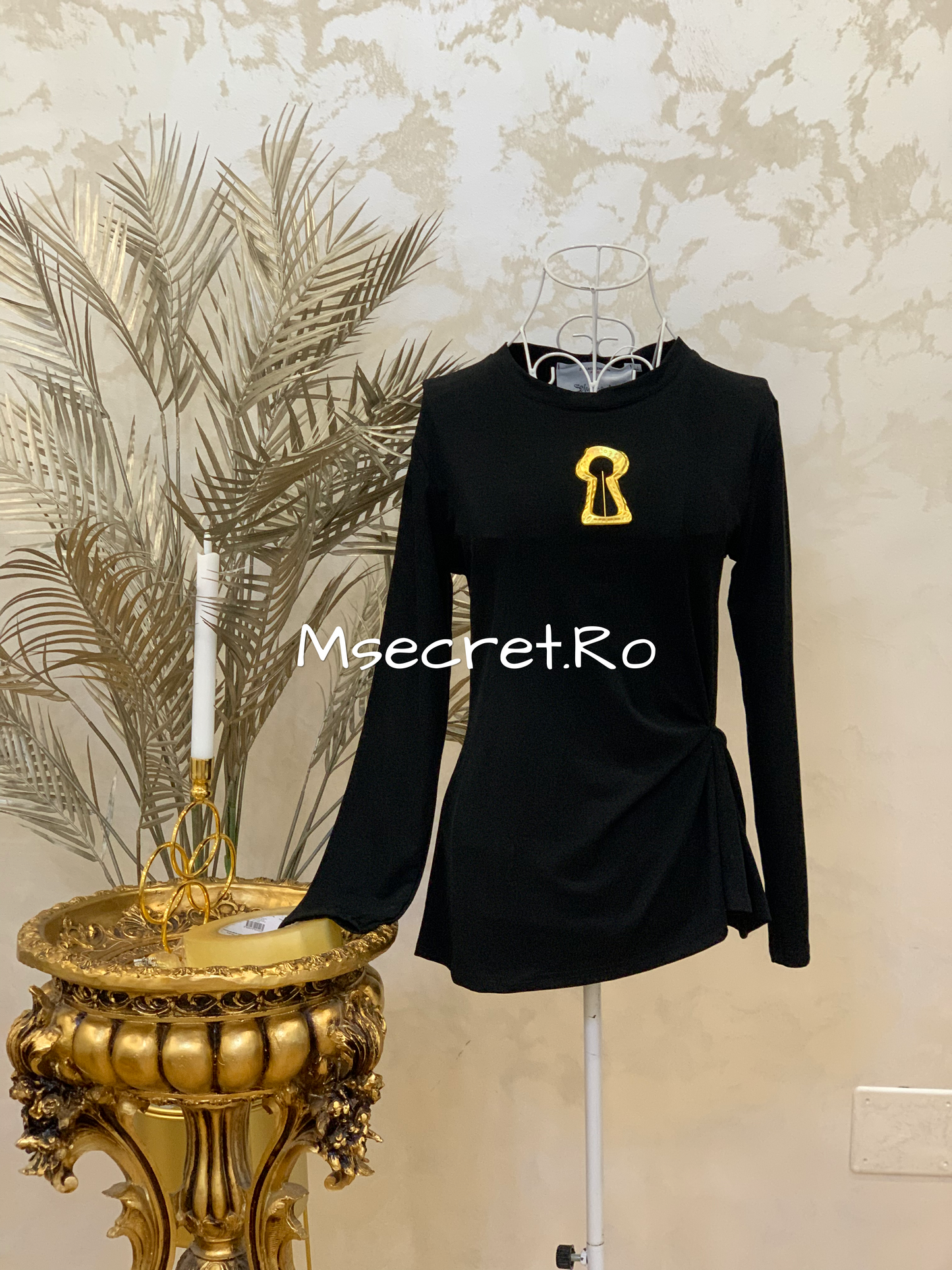 Black blouse with gold accessory
