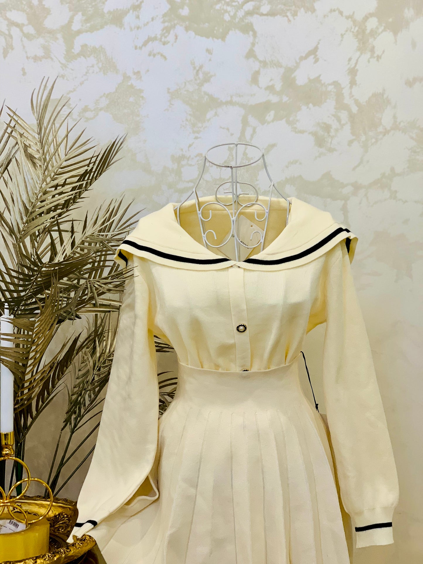 Cream set consisting of a pleated skirt and a sweater