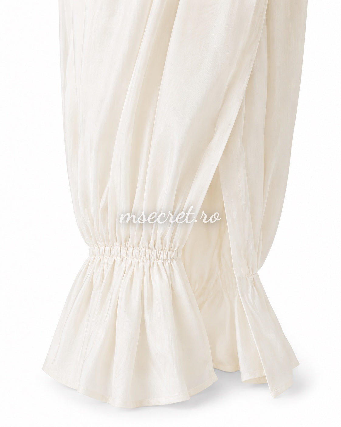 Loose ivory trousers with elasticated waist and ruffled hems