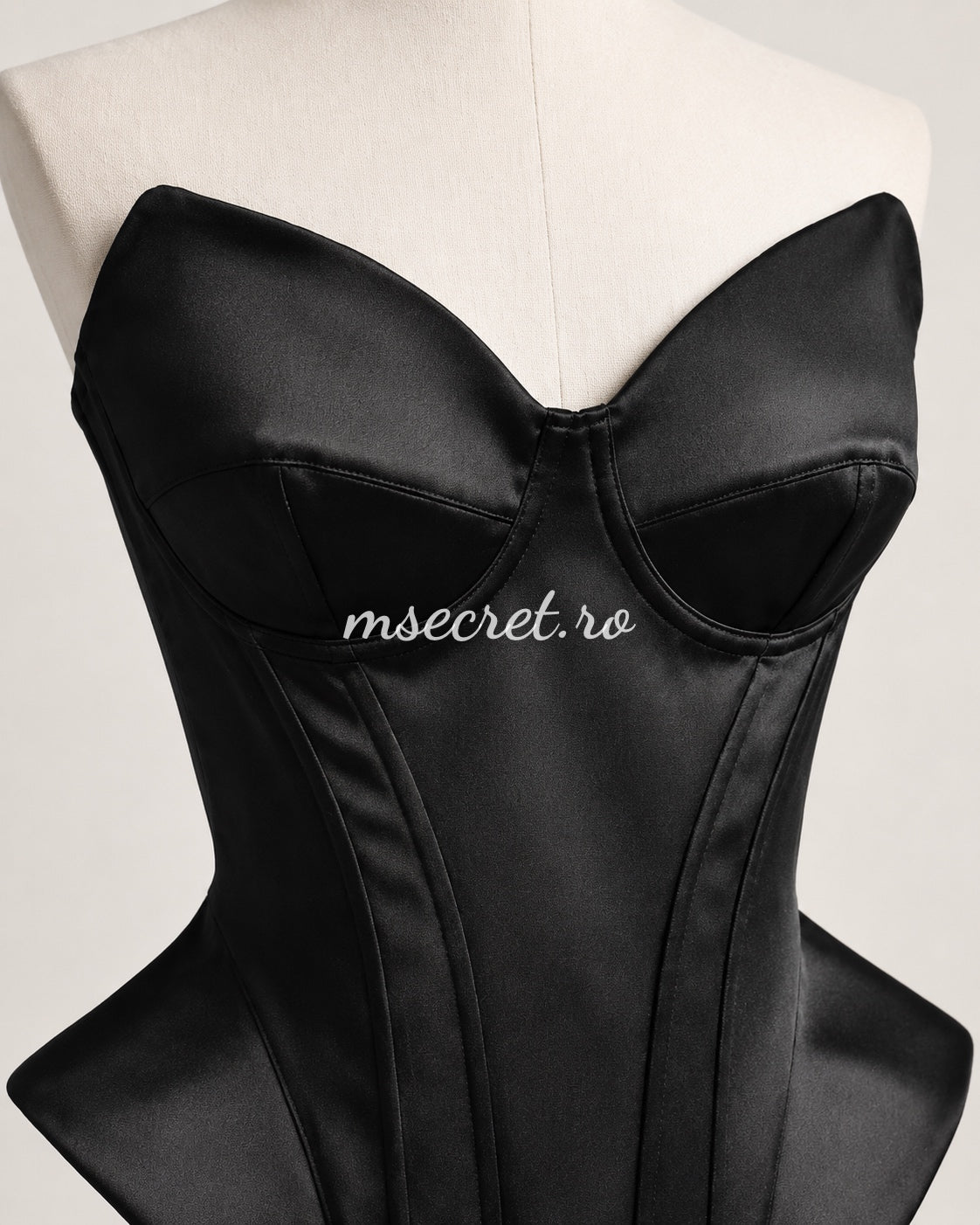 Black satin corset with contoured cups and sculptural design