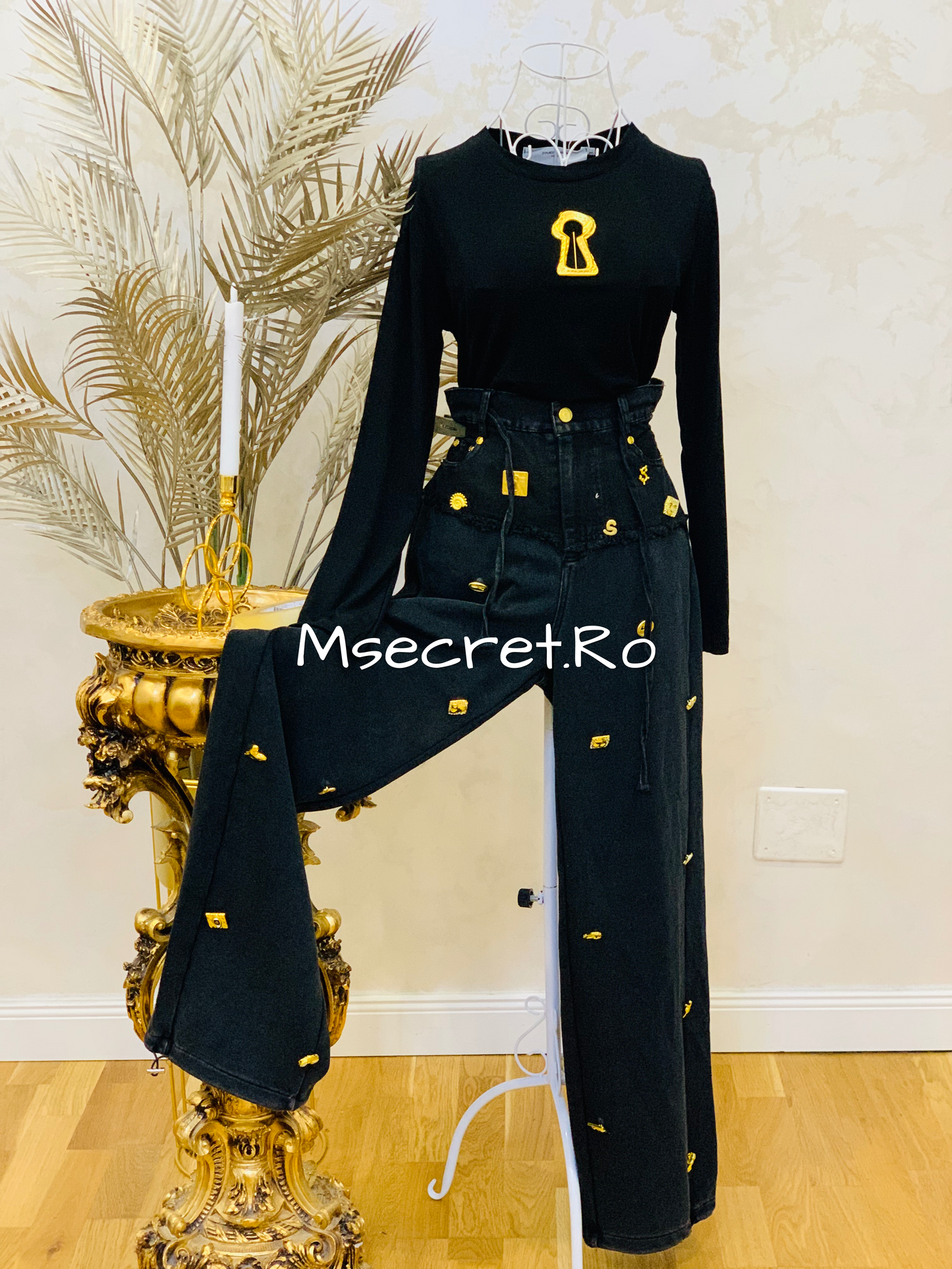 Black blouse with gold accessory